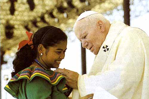 John Paul II caressing the chin of a young woman